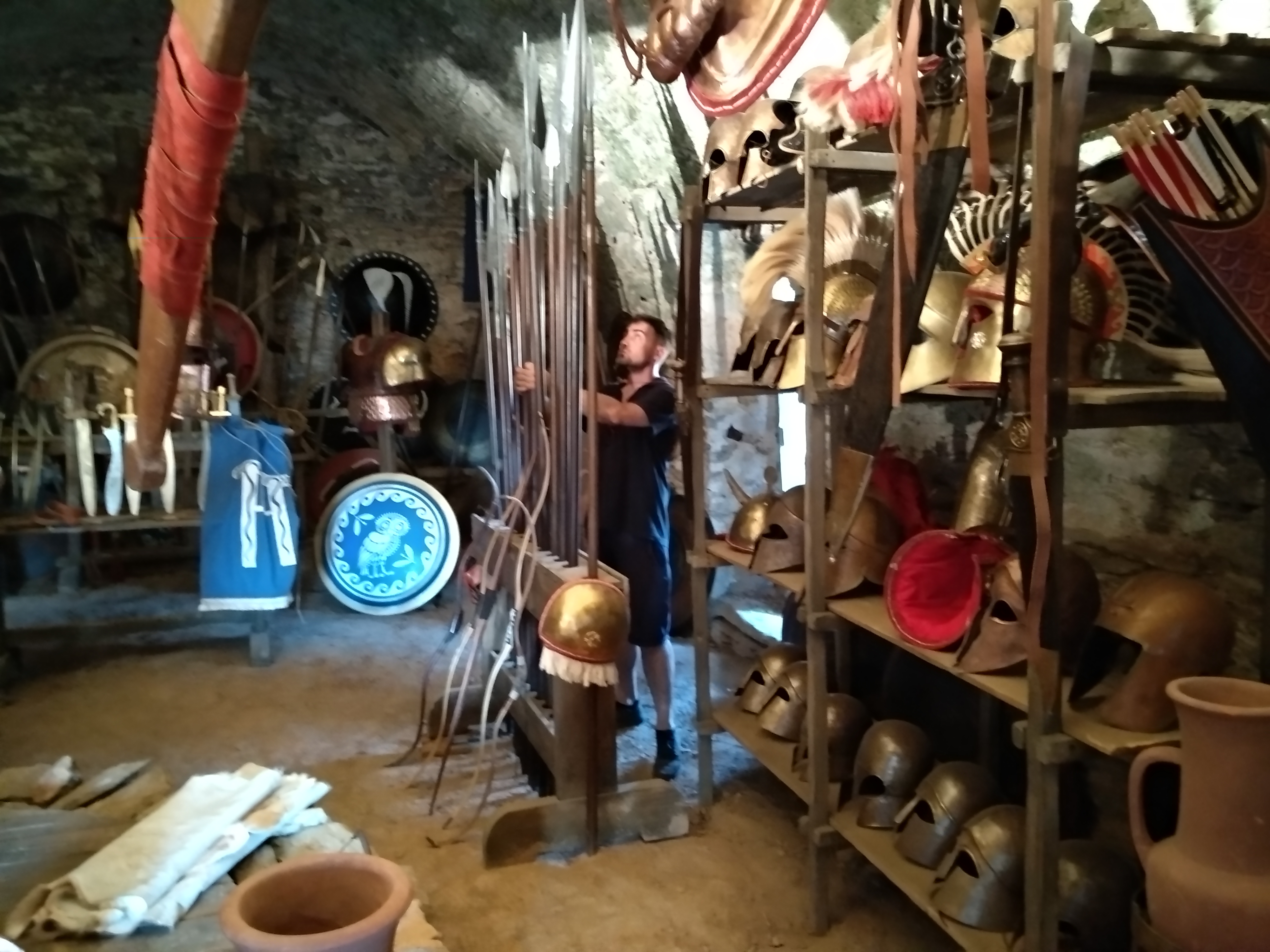 Georgios Katsos Working in the Historical Armour Production Archive Georgios Katsos working among reconstructed helmets, shields, spears and historical armour during production preparation in 2018