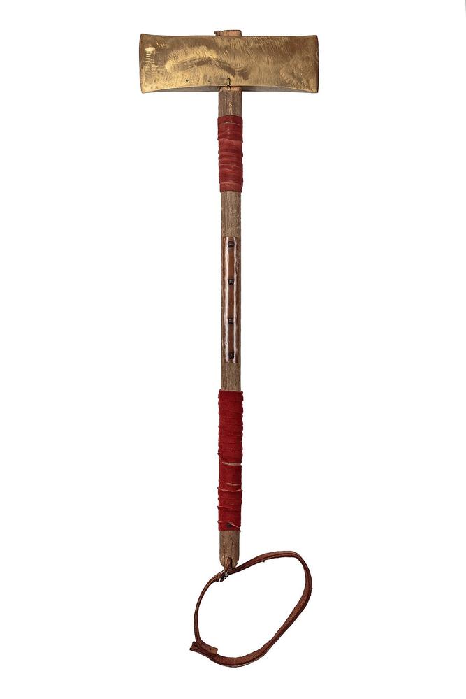 Broad reconstructed axe head on a long red-bound wooden haft