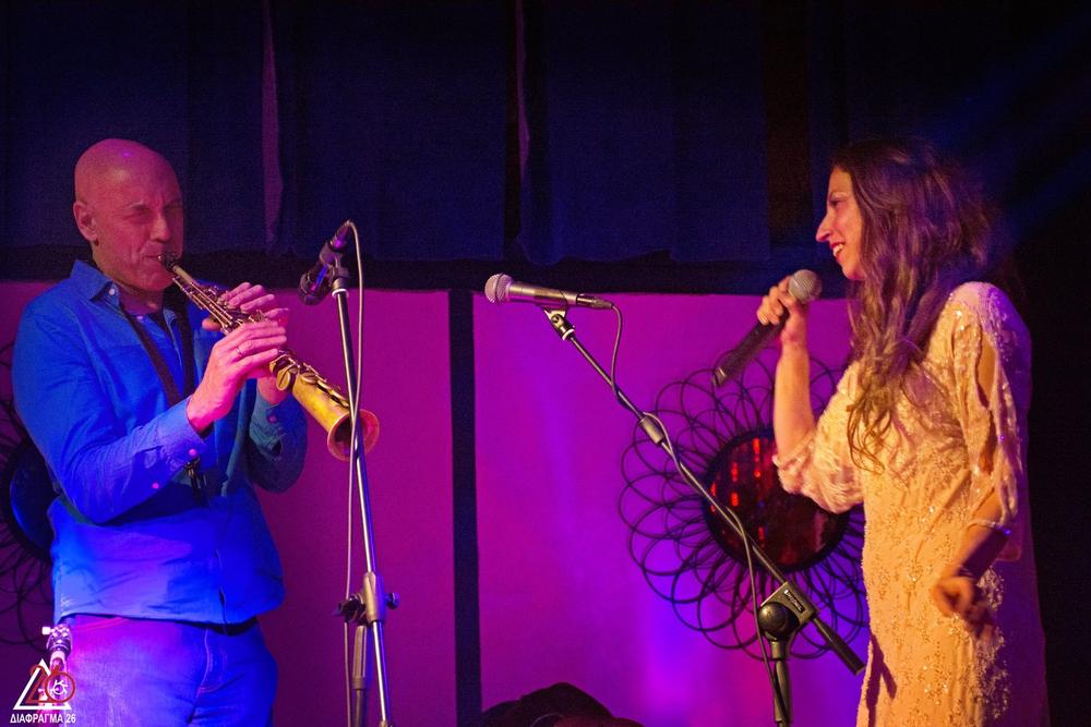 Male trumpet player and female vocalist performing together on stage