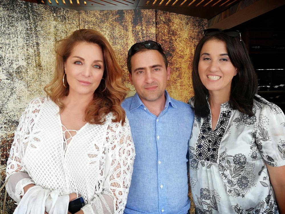 Three guests posing together during an Archaeopolis cultural event