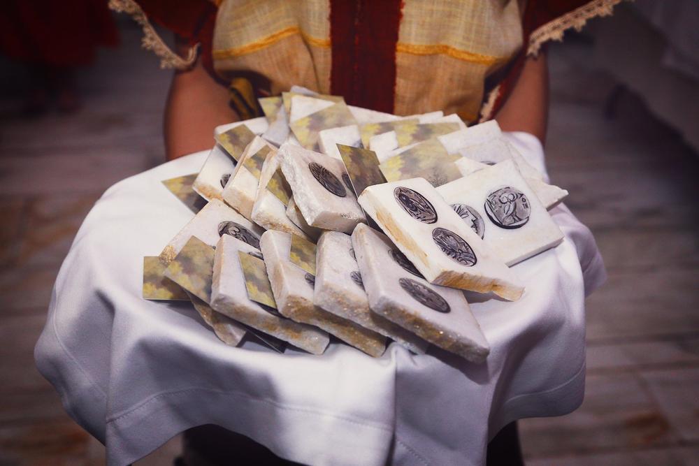 Wrapped food portions arranged on a table during a historical gastronomy presentation
