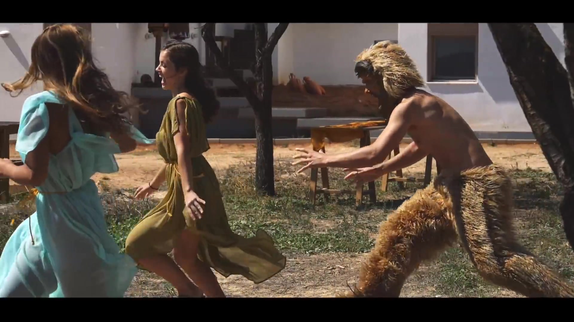 Costumed women turning through an outdoor ensemble dance sequence
