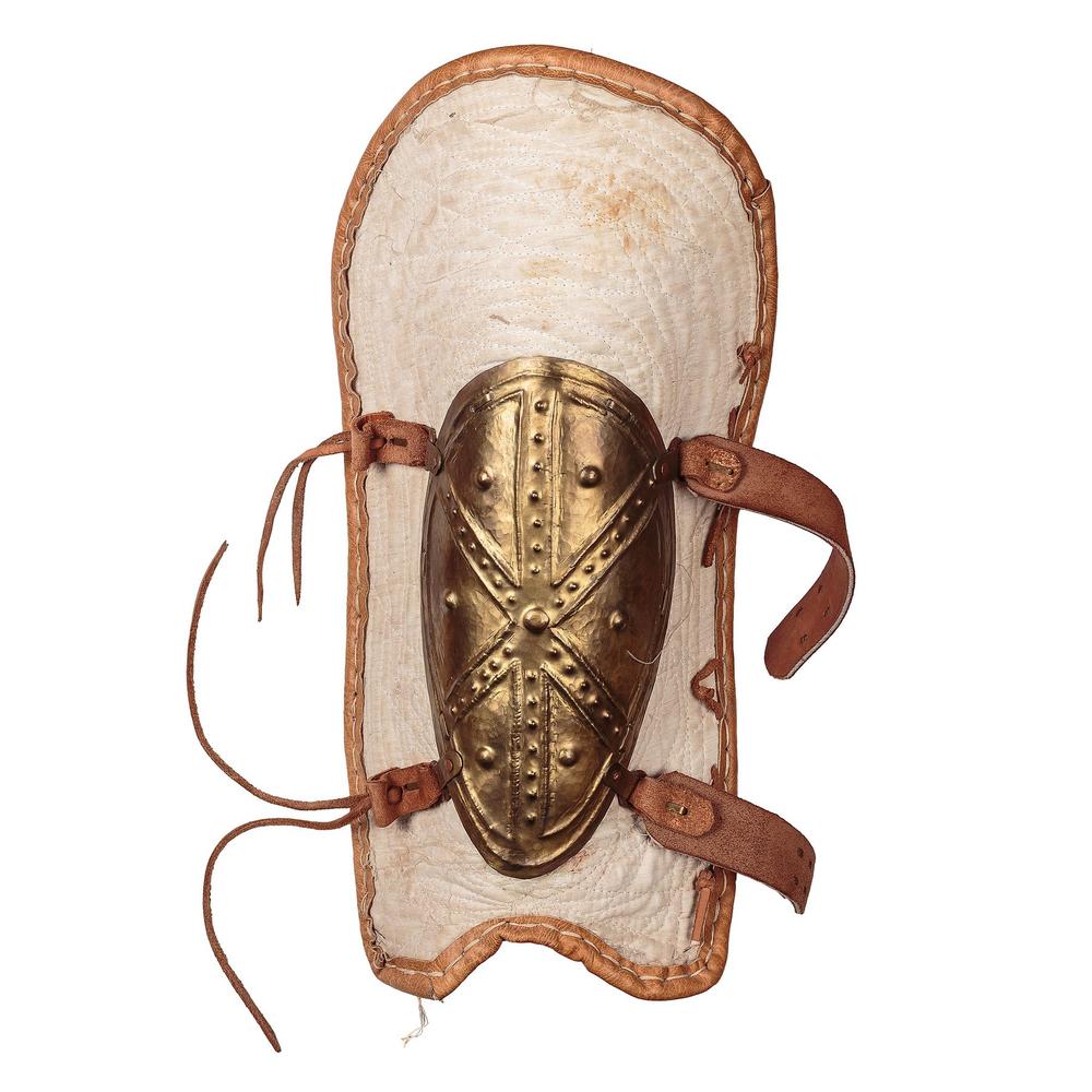 Decorated reconstructed bronze greave with leather ties and padded backing