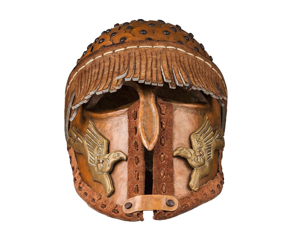 Ornately embossed bronze helmet with enclosed face guard and leather lining