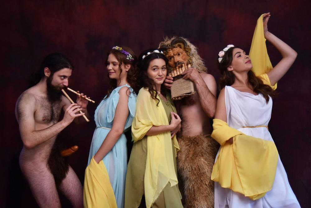 Pan and Two Nymphs by the Lake | Archaeopolis Performance Archive Performer portraying Pan beside a lake with two nymph performers in an Archaeopolis mythological scene