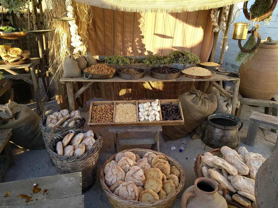 Assassin's Creed Odyssey Market Set Dressing Bread, dried foods, herbs and vessels arranged as an ancient market set for Assassin's Creed Odyssey filming