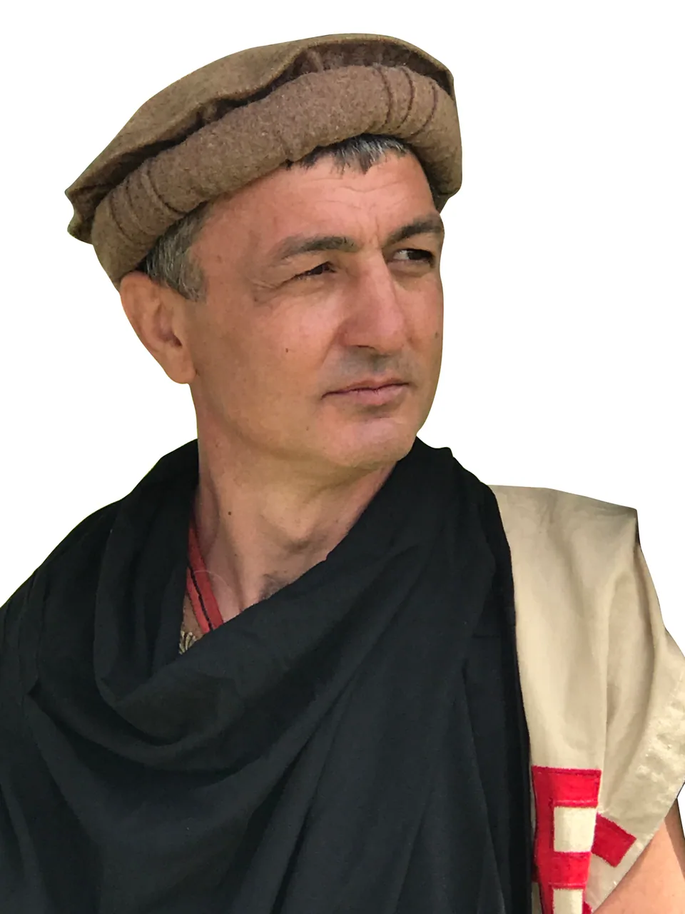 Costume portrait showing a brown flat cap with a rolled band, presented as a modern interpretation of the Macedonian kausia