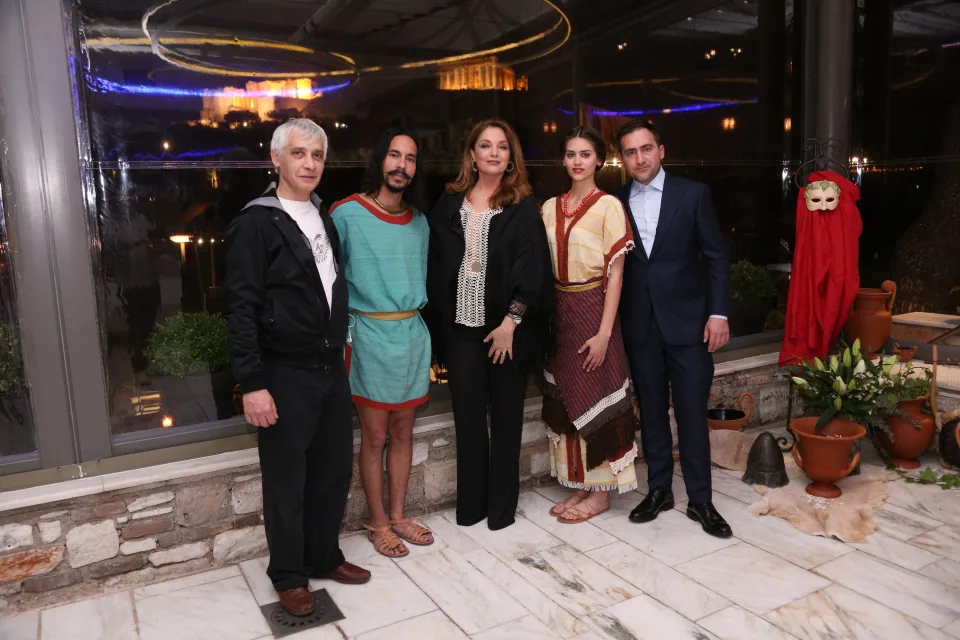 Angela Gerekou with Archaeopolis musicians, performers and collaborators after the private Ancient Greek birthday dinner, with the illuminated Acropolis behind them