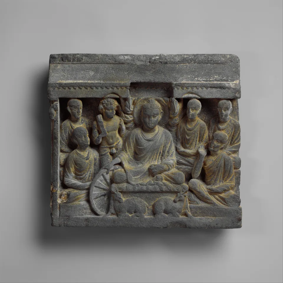 Vajrapani Attends the Buddha at His First Sermon — Gandhara Second-century Gandharan schist relief showing Vajrapani beside the Buddha at the First Sermon