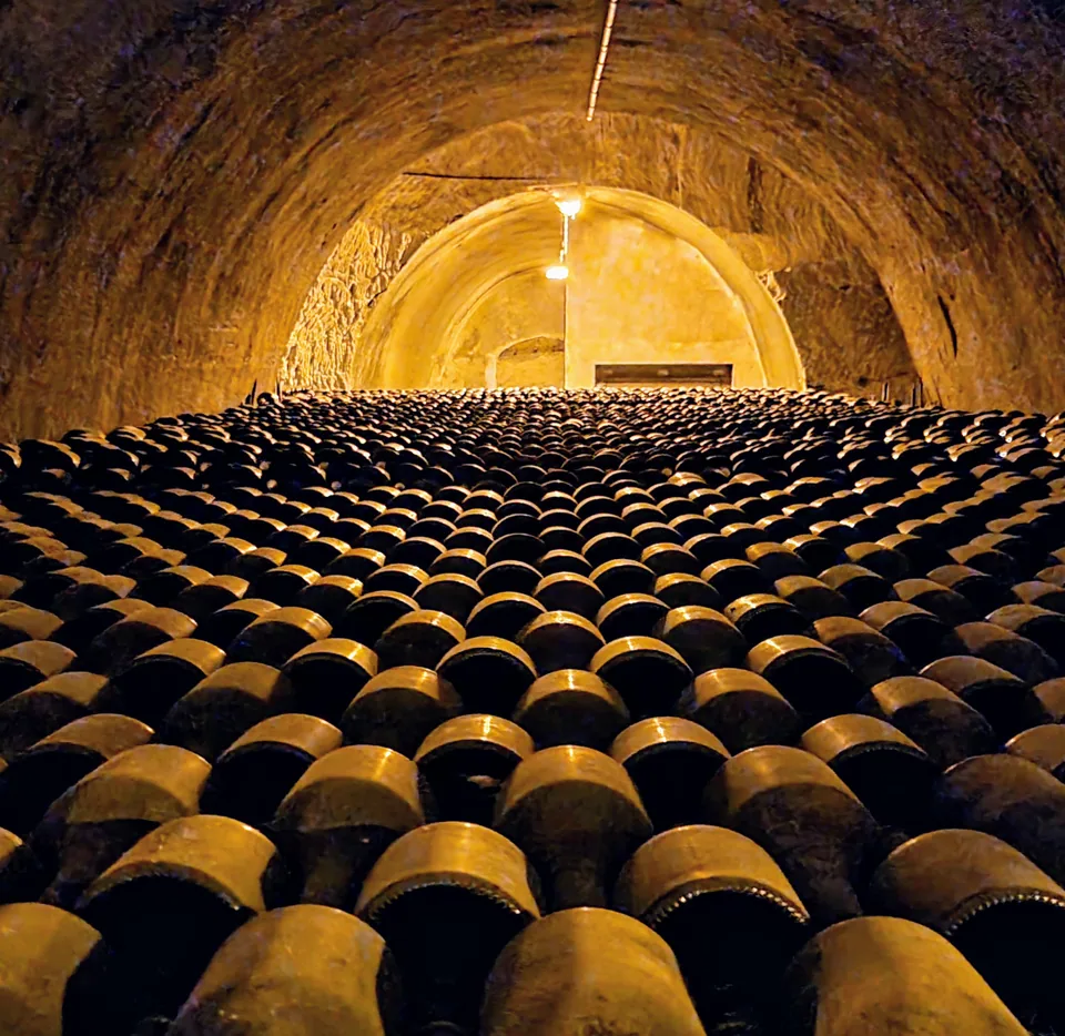 The Champagne behind the name Rows of Champagne bottles ageing in the Taittinger cellars in Reims