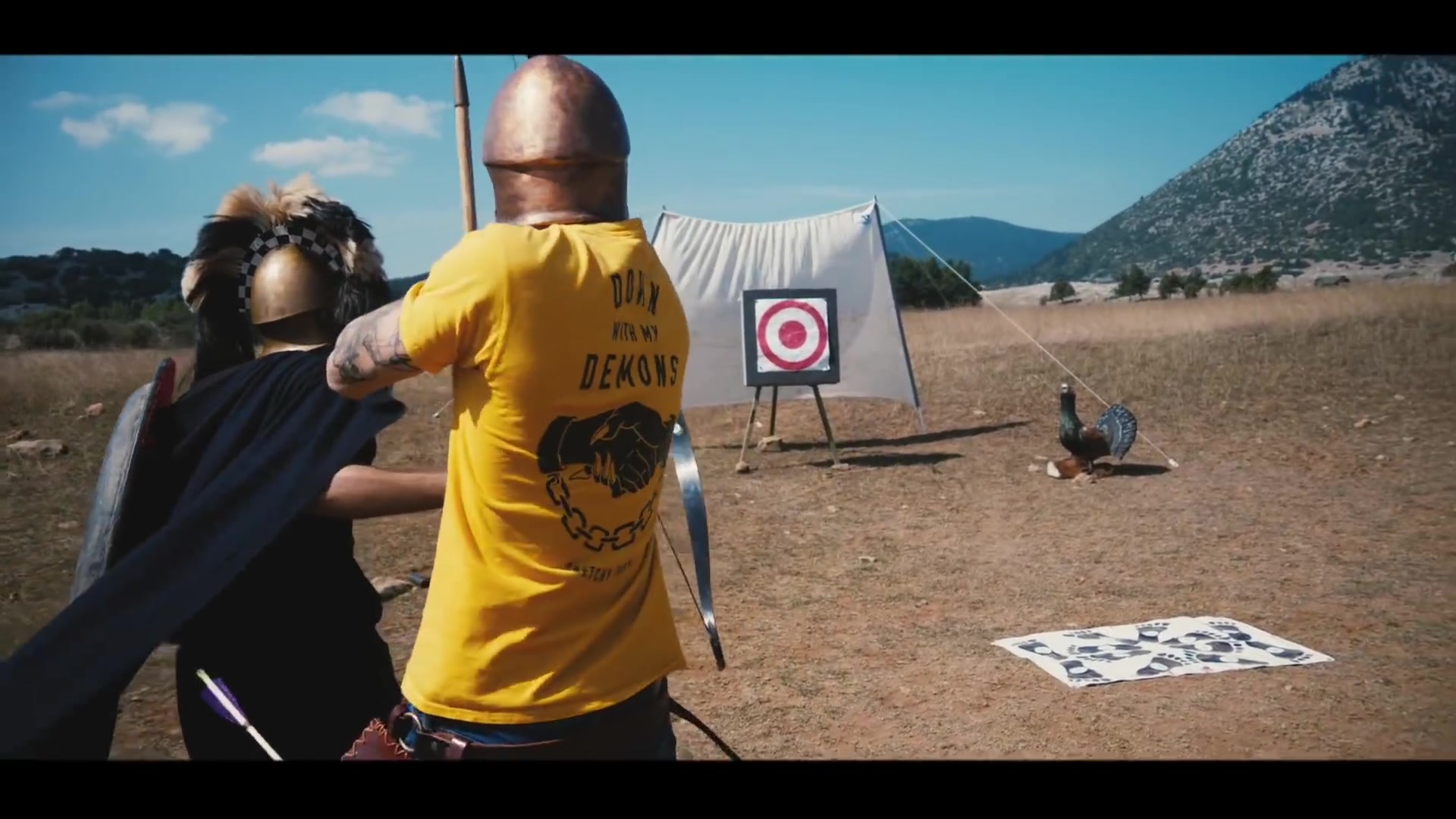 Close instruction before the shot | Archaeopolis Archery Games Instructor guiding a costumed participant's bow position before a shot