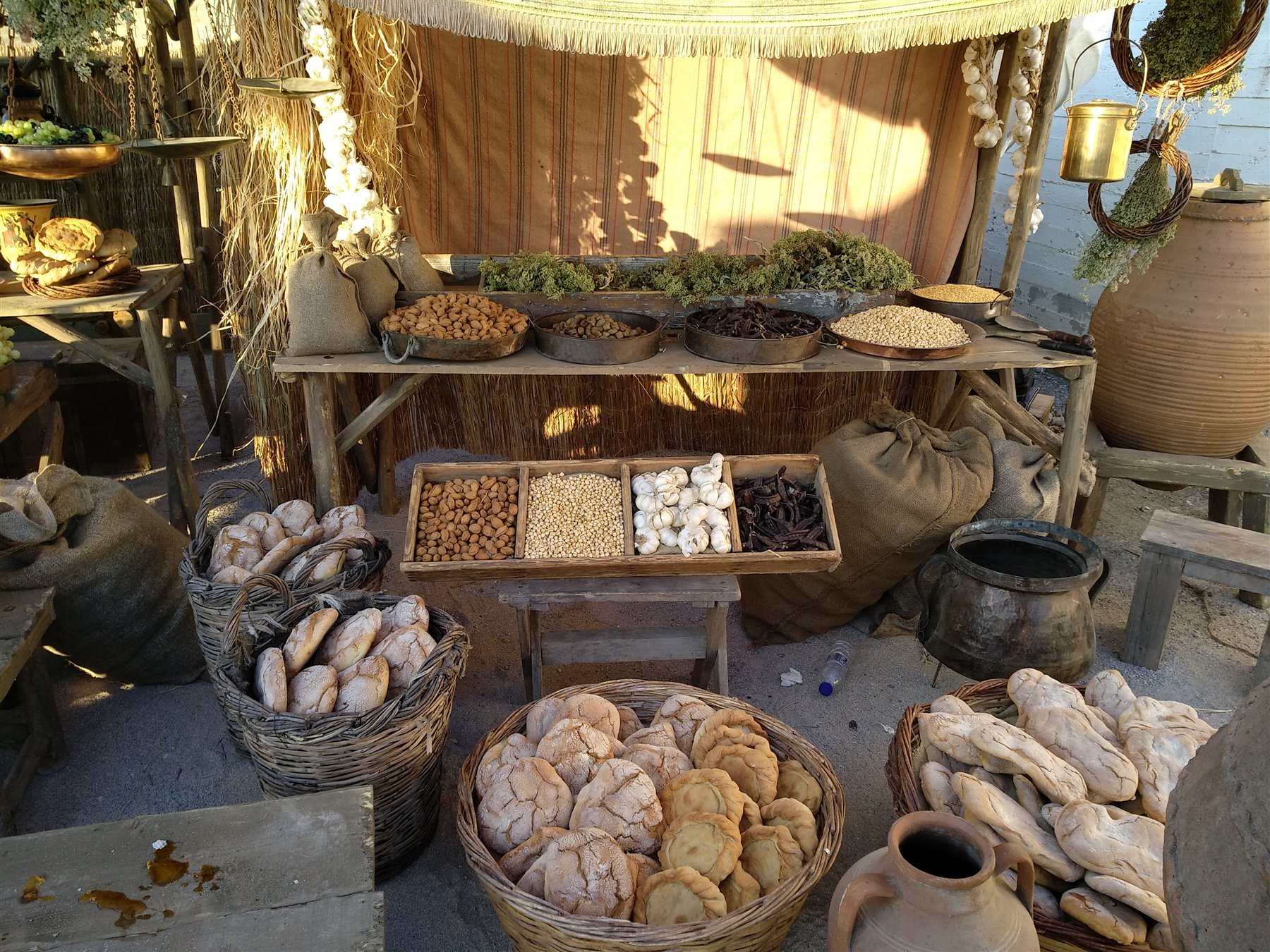 Assassin's Creed Odyssey Market Set Dressing Bread, dried foods, herbs and vessels arranged as an ancient market set for Assassin's Creed Odyssey filming