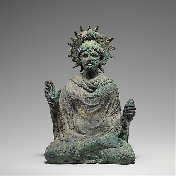 Seated Buddha and the Gandharan Classical Visual Vocabulary Seated Buddha from Gandhara wearing a robe arranged in deeply modelled classical-style folds