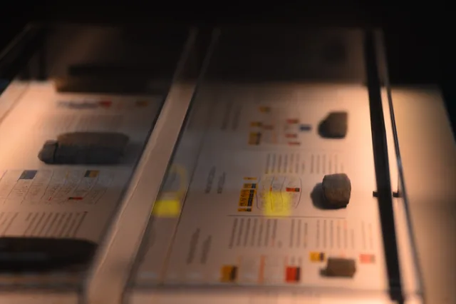 Angled display of inscribed clay tablets and explanatory diagrams.