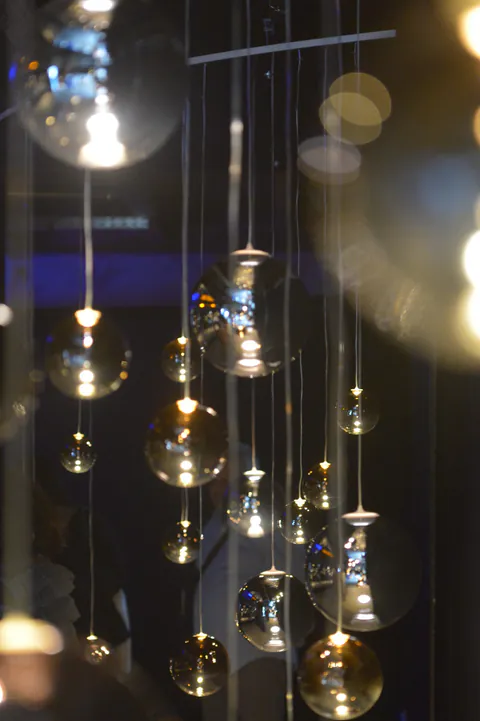 Warm glass-light reflections at a private dining event in Mykonos