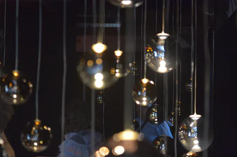 Suspended glass lights at an Archaeopolis private dining event in Mykonos