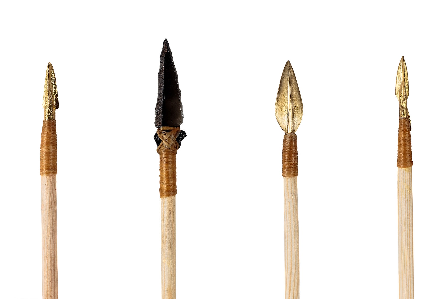 Four arrowheads with different profiles mounted and bound to wooden shafts