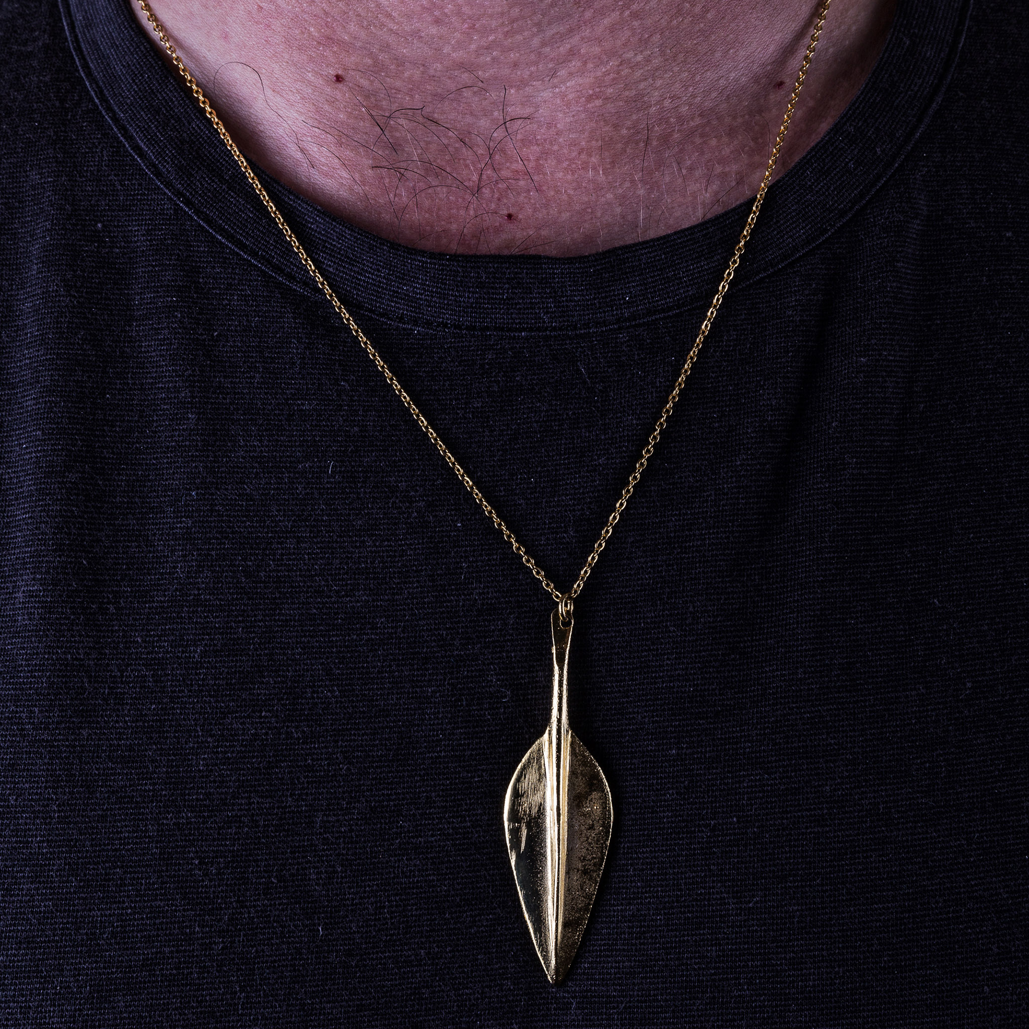 Gold-toned leaf-form spearhead pendant worn on a fine chain, Archaeopolis Objects archive