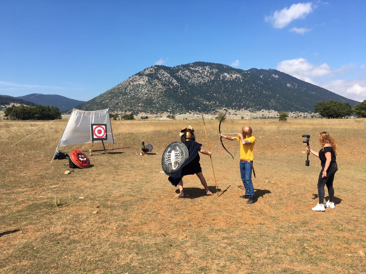 Archery activity filmed in an open Greek landscape