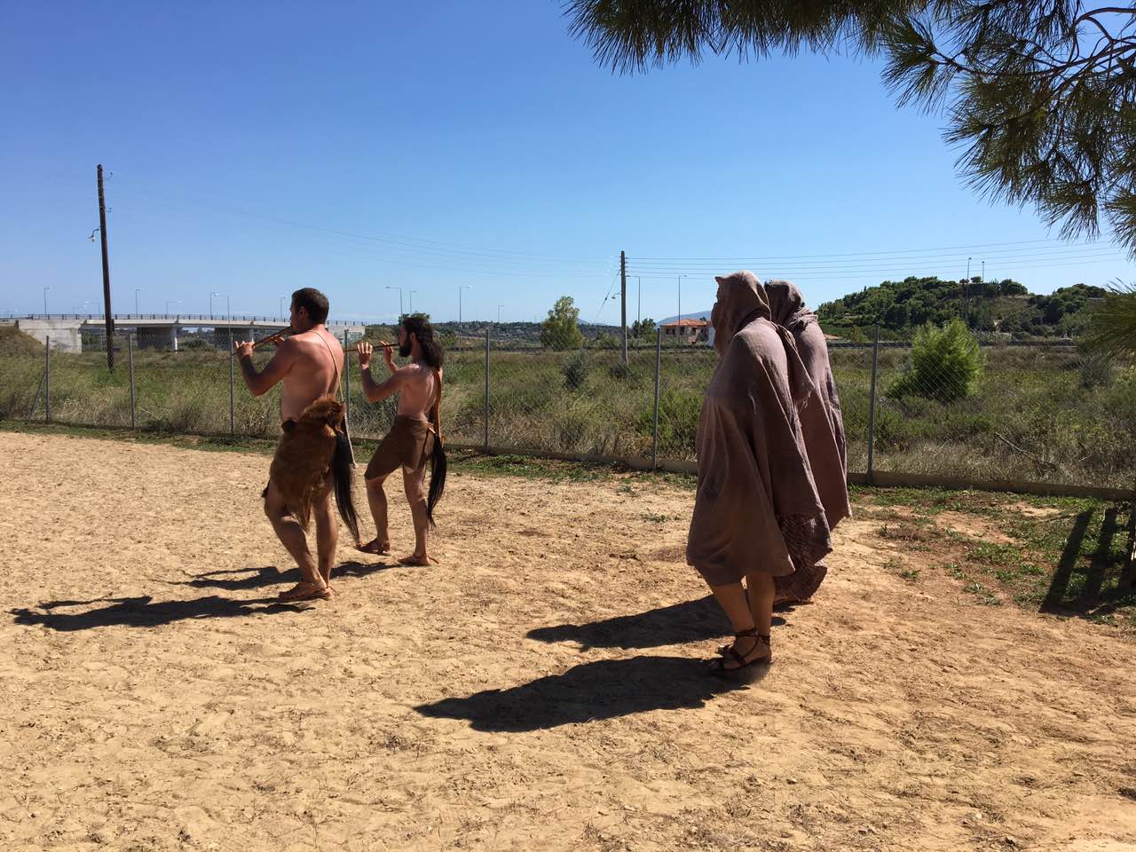 Musicians and cloaked performers in procession