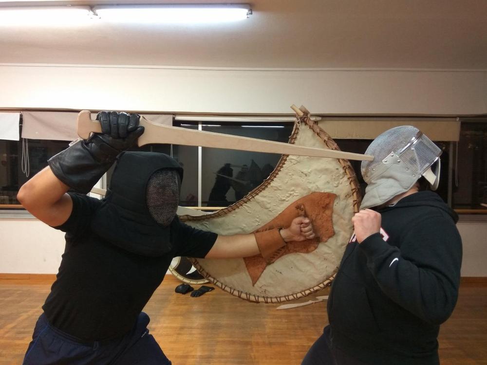Close Helmet Sparring | Athens Hoplites Project Helmeted students practising controlled close-range sword contact