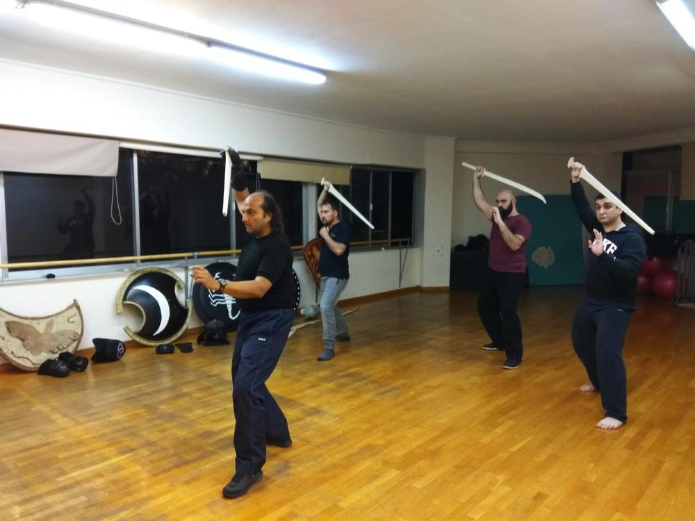 Group Sword Drill | Athens Hoplites Project Athens Hoplites students practising an overhead sword drill in the training hall