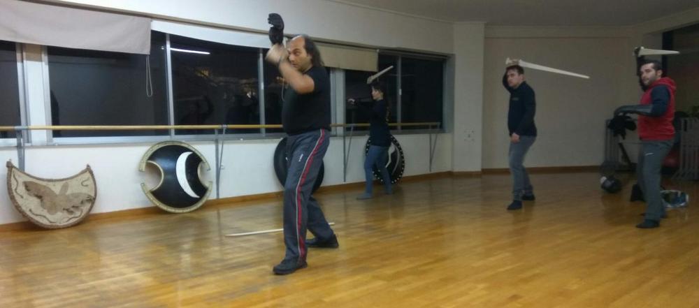 Solo Guard Practice | Athens Hoplites Project Student rehearsing a two-handed overhead guard during sword training