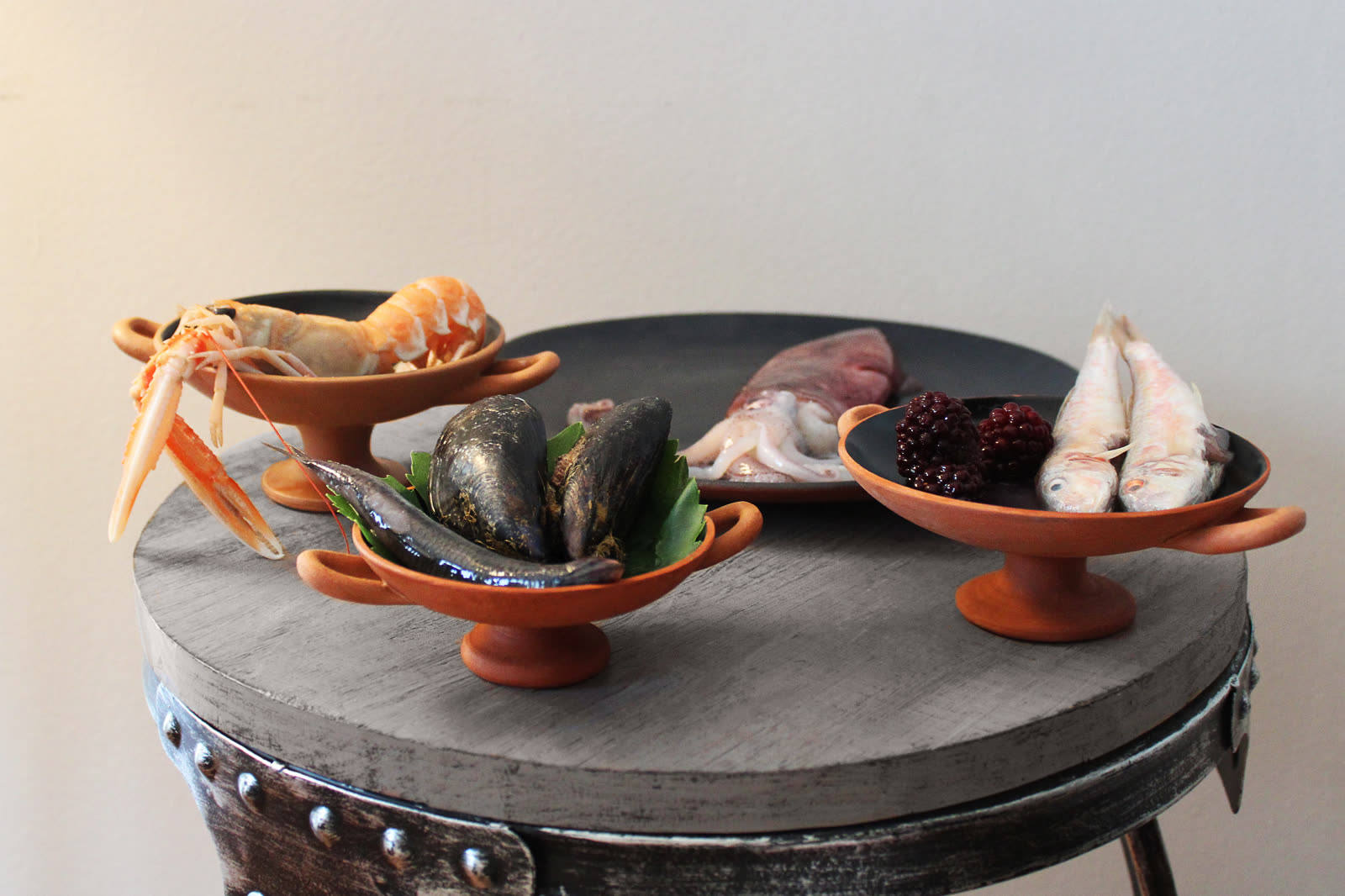 Fish, squid, mussels and shellfish displayed in reconstructed vessels for the Mykonos event
