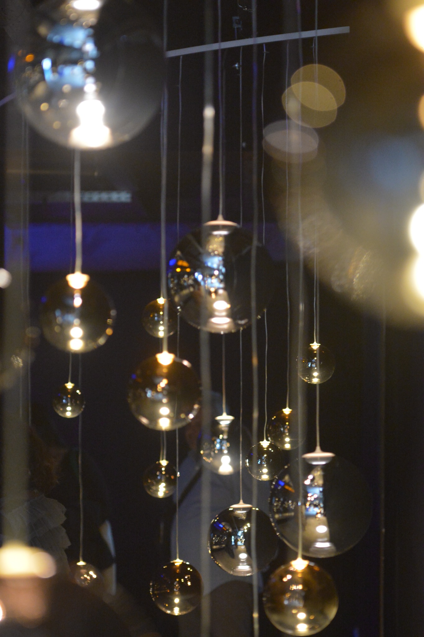 Close view of glass lights and warm reflections at the private Mykonos event