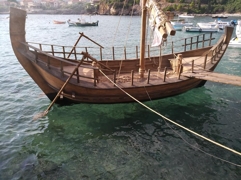 Archaeopolis Olkas ship floating beside the coast during a historical event