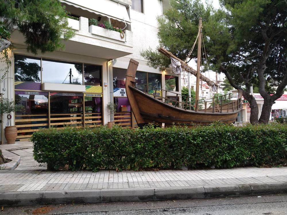Ship in the City | Archaeopolis Olkas Ship Archaeopolis Olkas ship integrated into an urban streetscape installation