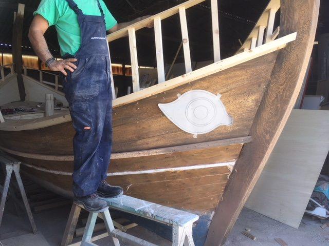 Finishing the Bow | Archaeopolis Olkas Ship Craftsperson working on the reconstructed bow and eye detail of the Olkas ship