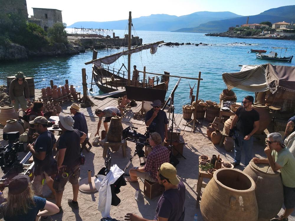 A Ship at the Centre of the Event | Archaeopolis Olkas Ship Audience gathered around the Olkas ship during a seaside Archaeopolis programme