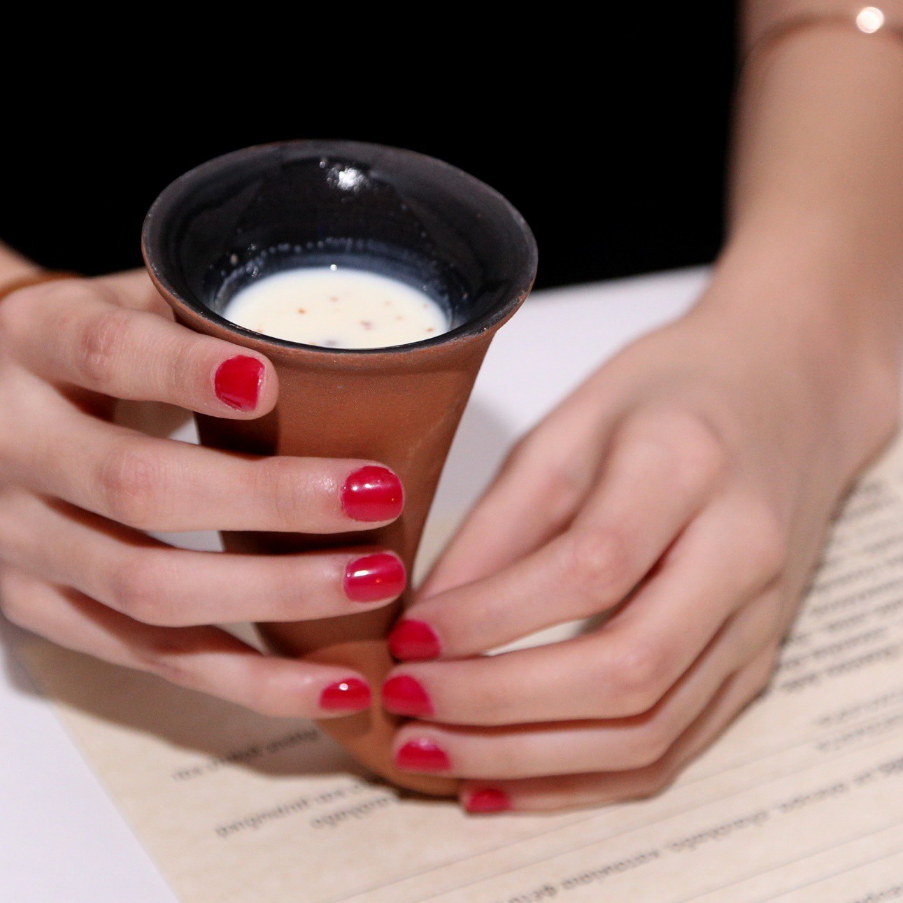 Ceramic cup holding a historically inspired drink developed for an Archaeopolis symposium concept