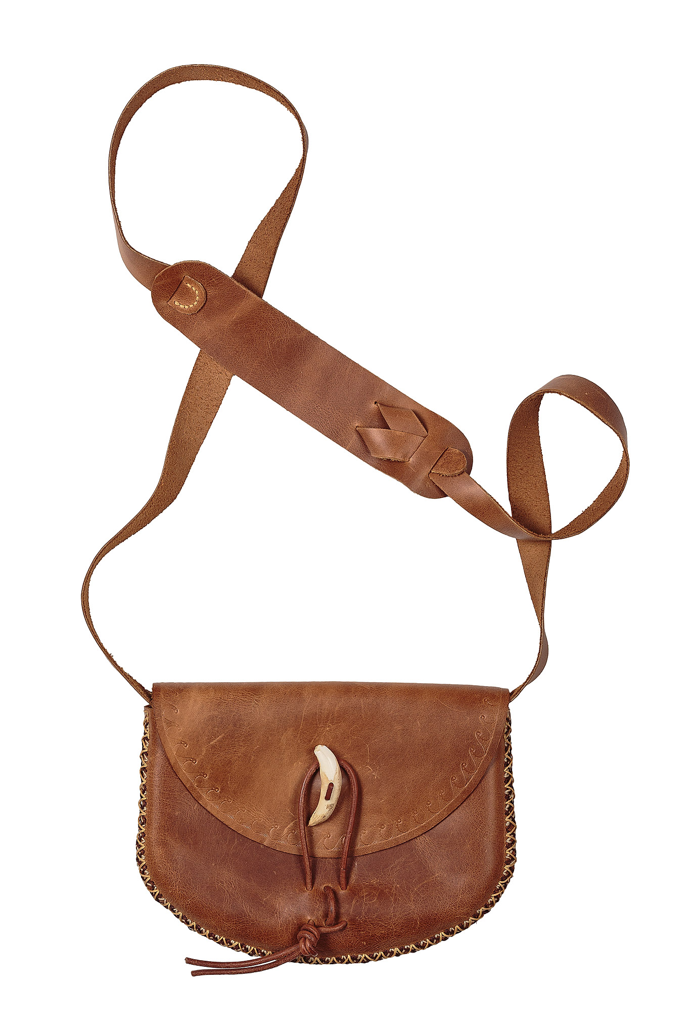 Brown leather bag with a broad adjustable strap and a pale toggle closure
